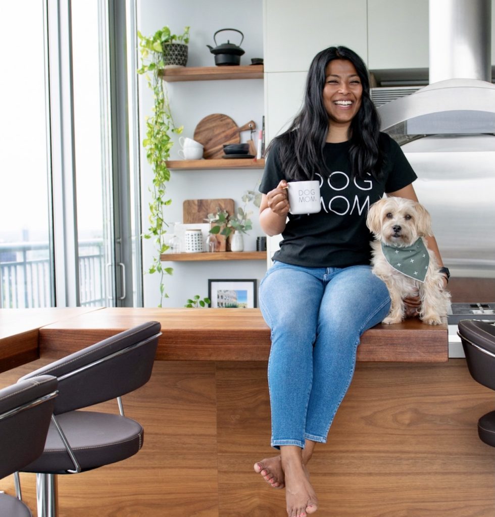 
Sharon and Teddy are sitting on the kitchen counter. Sharon is wearing a dog mom shirt and drinking coffee from a dog mom mug.