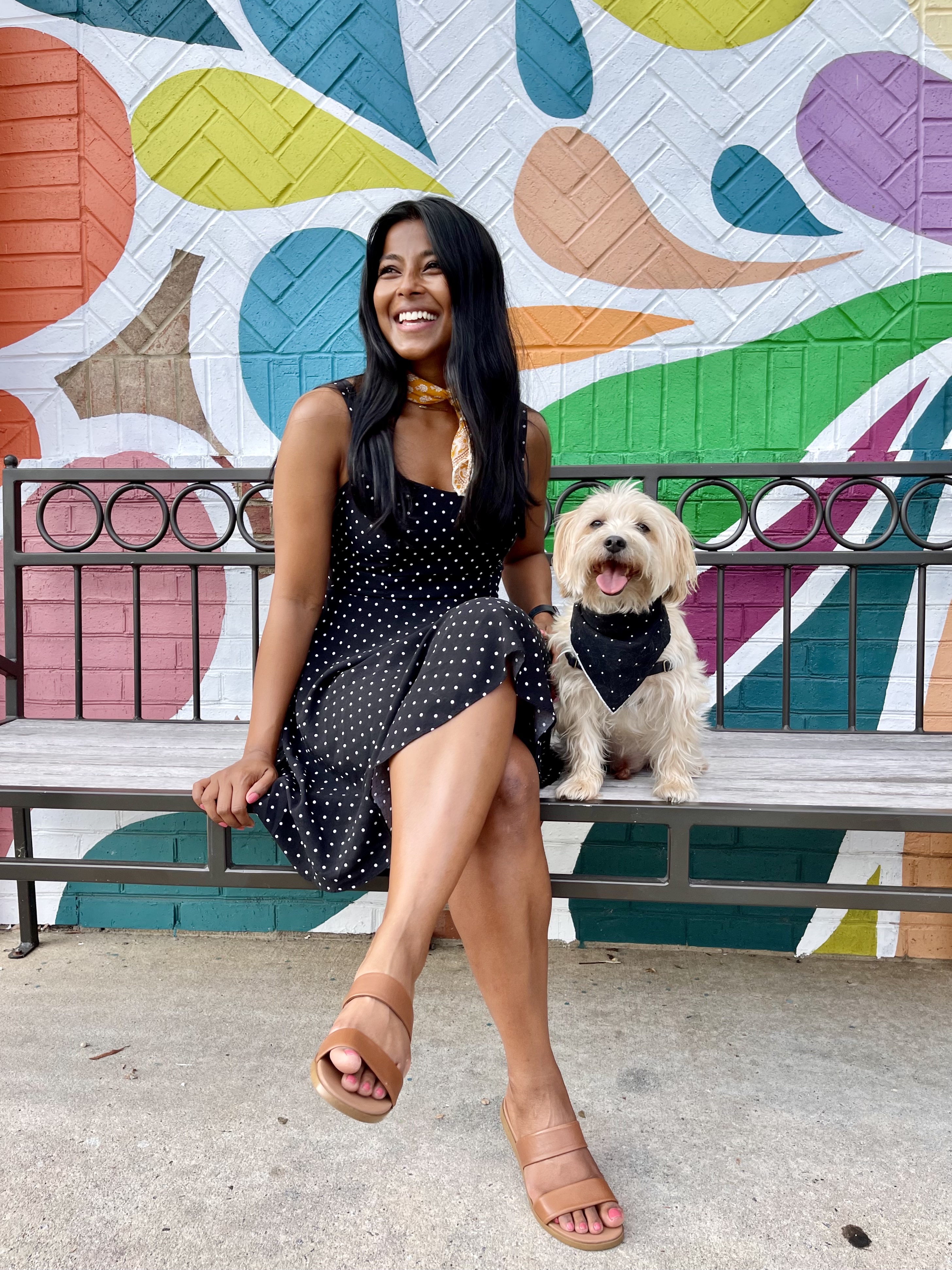 simply-sharon-and-teddy-wearing-matching-black-polka-dot-outfits-in-front-of-a-colorful-mural-1
