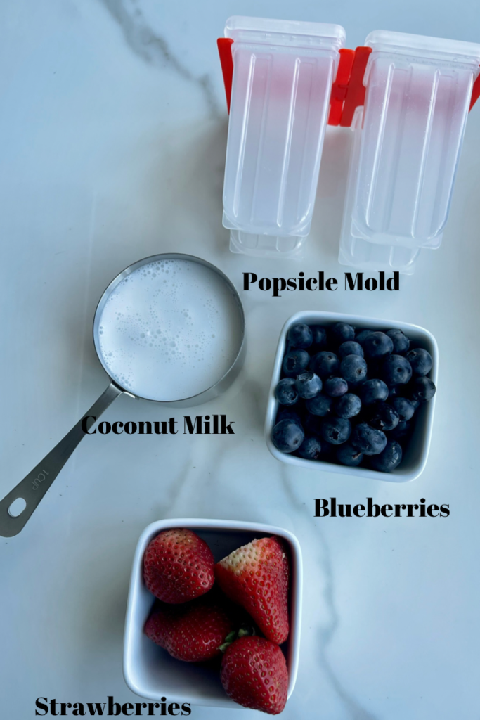 the ingredients needed for red white and blue dog popsicles are blueberries, strawberries, coconut milk, water and popsicle mold.