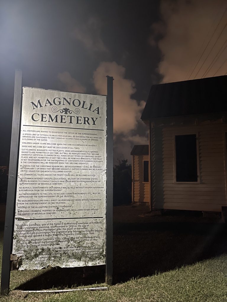 A spooky sign of Magnolia Cemetry at night in Charleston SC