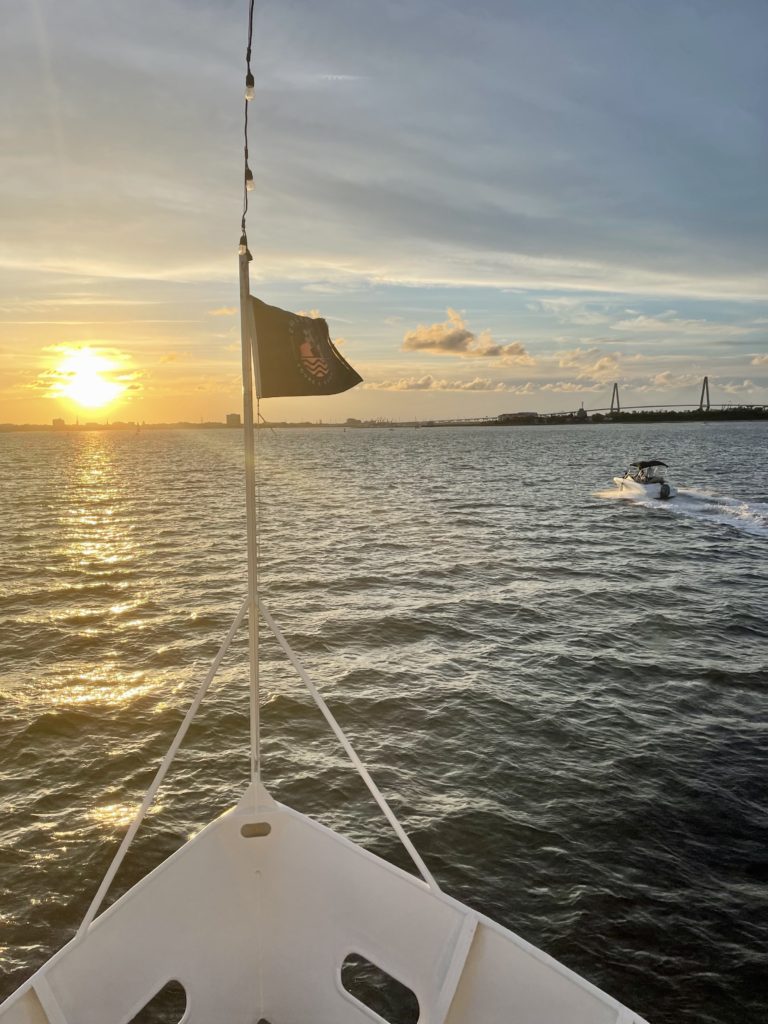 sun setting on Charleston harbor from a ferry boat
