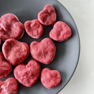 an assortment of heart beet dog treats on a plate