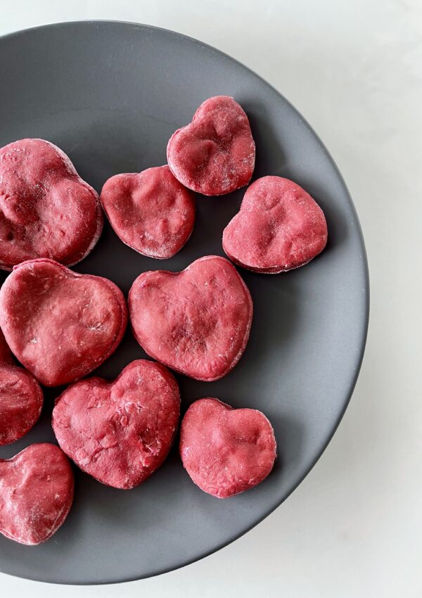 an assortment of heart beet dog treats on a plate