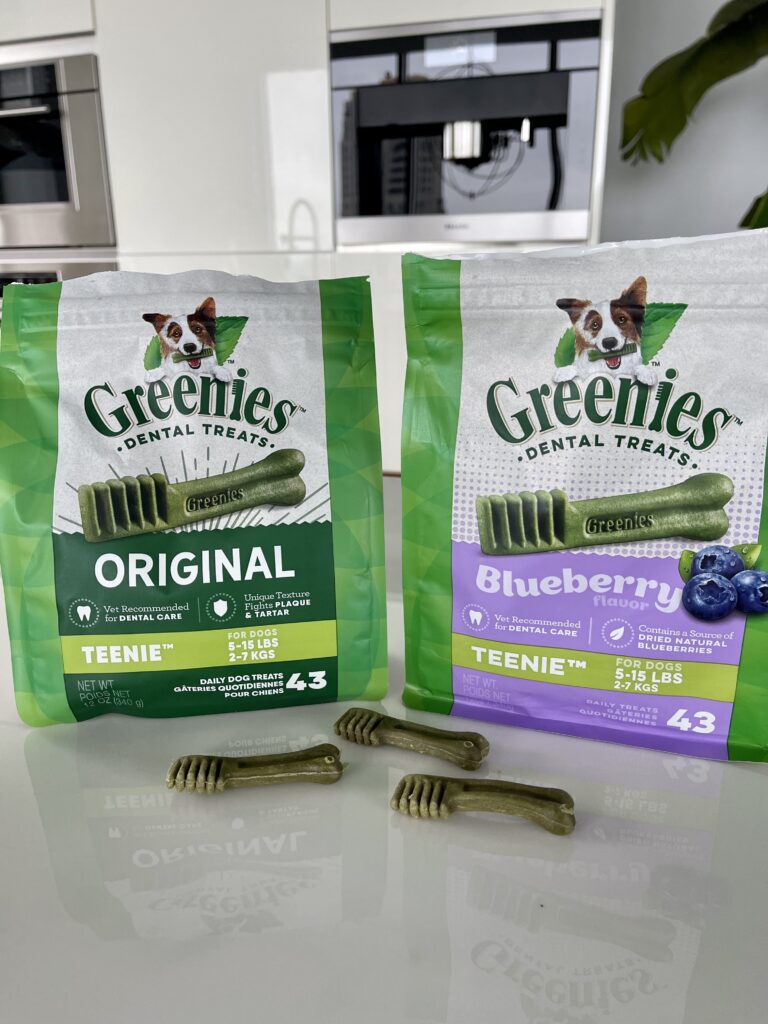 two packages of greenies dental treats sit on a kitchen counter