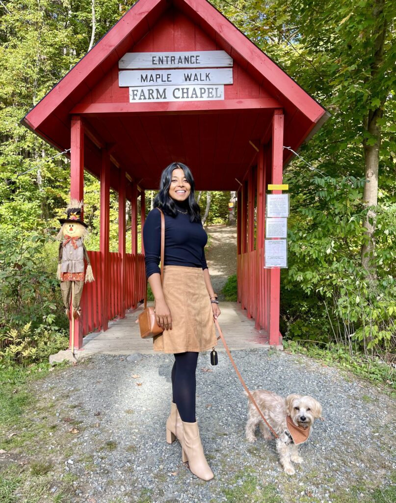Sharon and her dog teddy stand at the entrance of Sugar Bush Farm in Woodstock Vermont