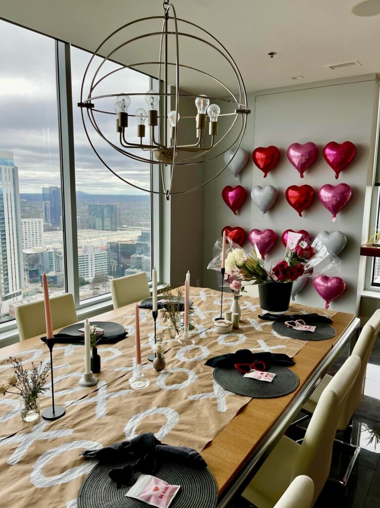 Galentine's day decor with balloon hearts on wall and table scape