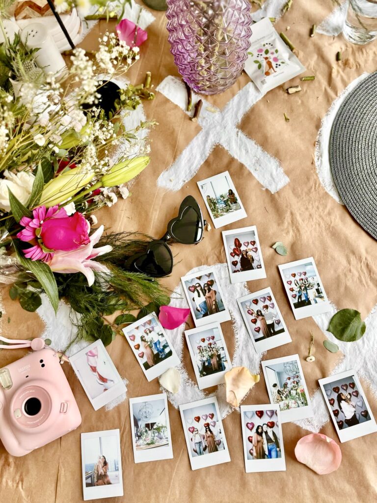 Instax and polaroid photos from valentine's day brunch on table