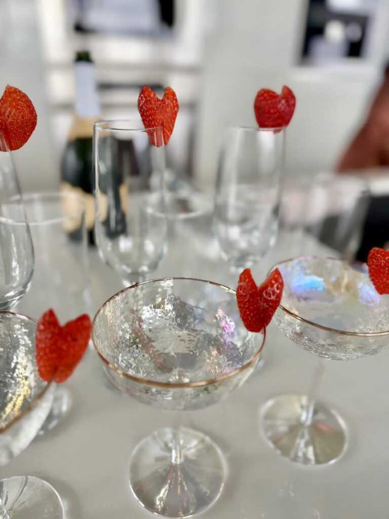 glassware with heart shaped strawberies on the edge
