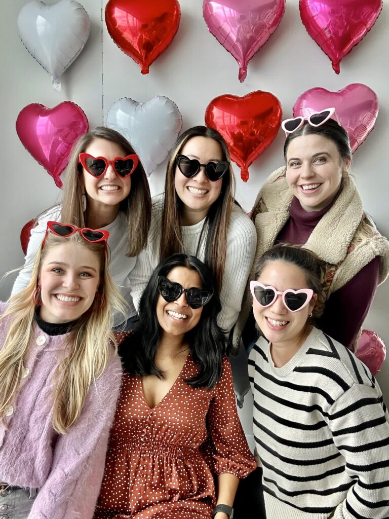 6 dog moms wearing heart glasses at Galentine's day party